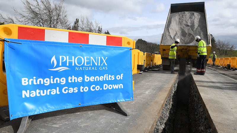 Image featuring a Phoenix sign and workers involved in installing new gas lines in Co Down.