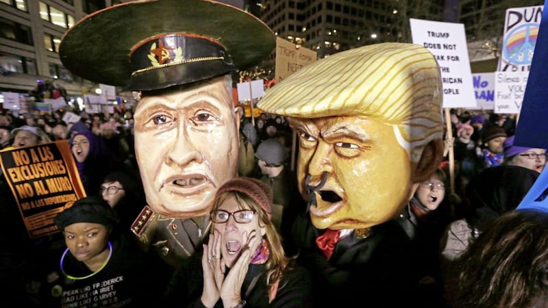 A woman in Seattle shouts out as she stands in front of giant puppet heads portraying Vladimir Putin and Donald Trump at rally to oppose Trump's executive order barring people from certain Muslim nations from entering the US. Picture by Elaine Thompson, Associated Press