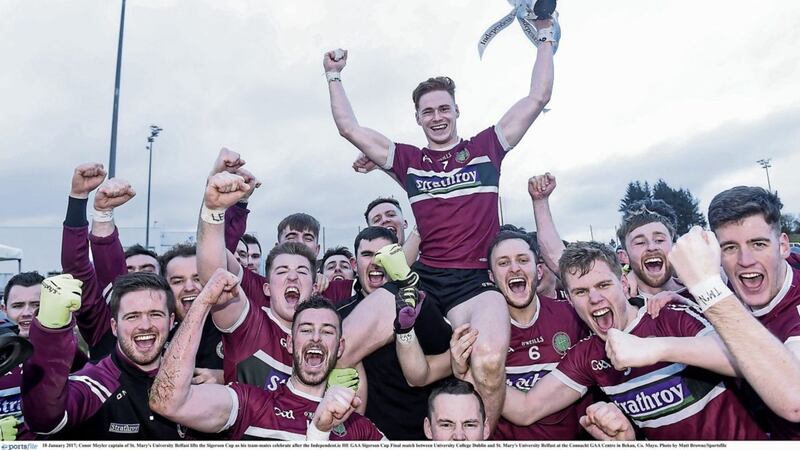 Conor Meyler, captain of St Mary&#39;s University Belfast, lifts the Sigerson Cup as his team-mates celebrate after their Sigerson Cup win last weekend 
