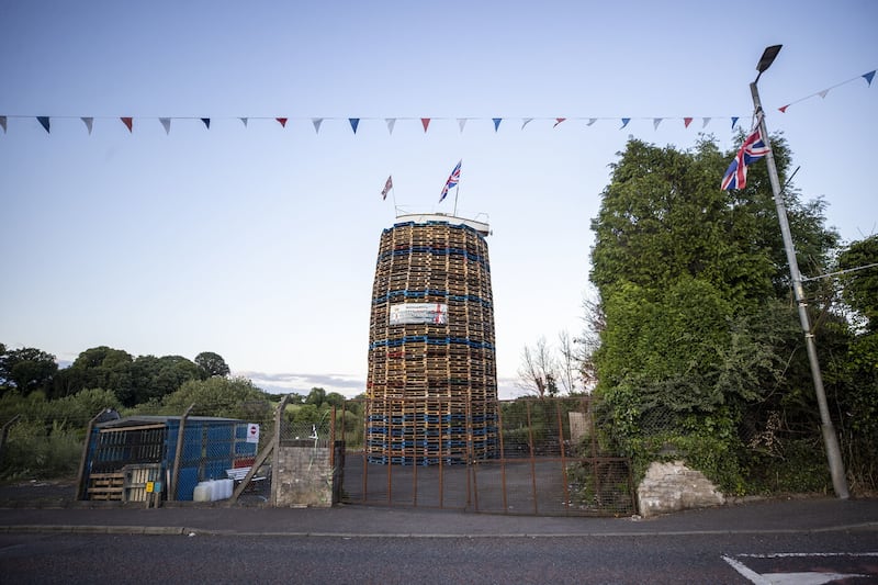 A boat flying the Union Jack flag placed on the top of the pyre with a banner that reads "No Irish Sea border"  on the Moygashel bonfire in Co Tyrone. Picture by Liam McBurney/PA Wire