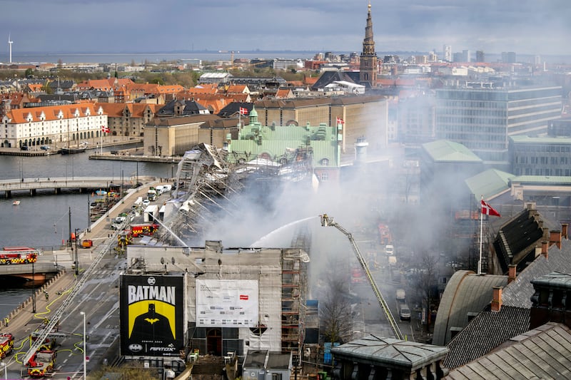 Firefighters work on the building after the fire broke out (Ida Marie Odgaard/AP)