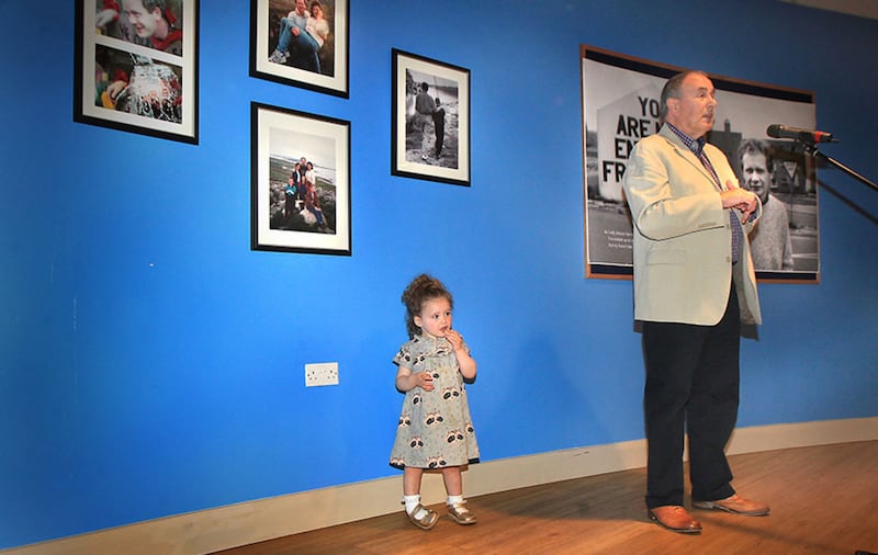 Sadhbh McGuinness (2), granddaughter of the late Martin McGuinness, watches as Mitchel McLaughlin addresses the official opening of the exhibition 'Martin' at the Gasyard centre in Derry's Bogside&nbsp;