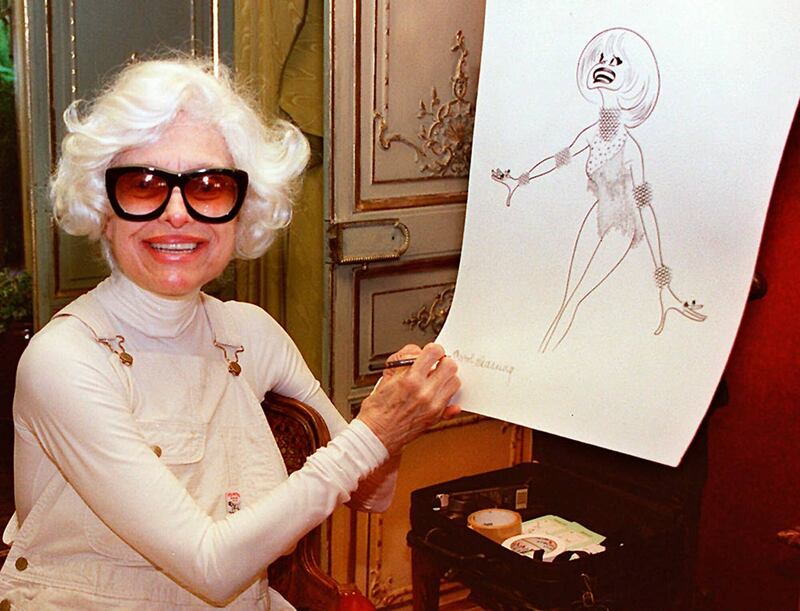 Channing signing a lithograph of herself by caricaturist Al Hirschfeld