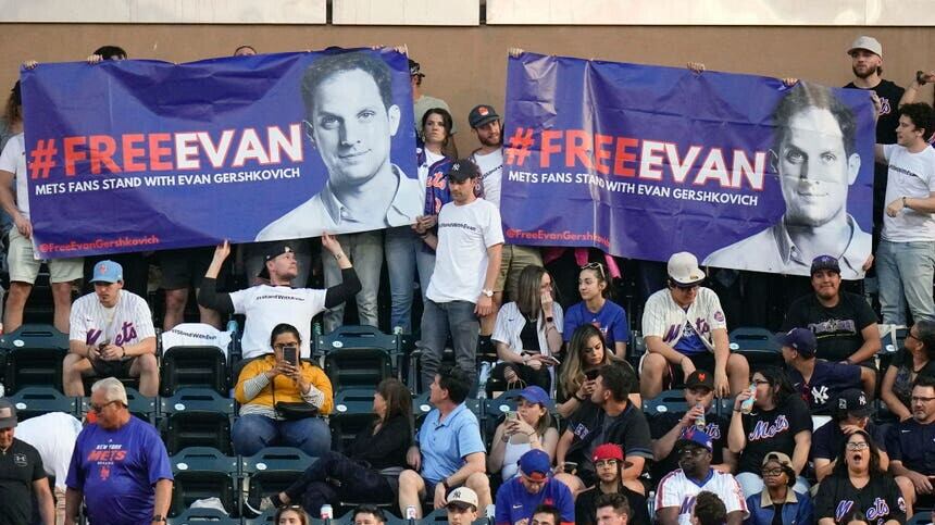 Supporters of Wall Street Journal reporter Evan Gershkovich hold a sign for him during the third inning of a baseball game between the New York Mets and the New York Yankees (Frank Franklin II/AP)