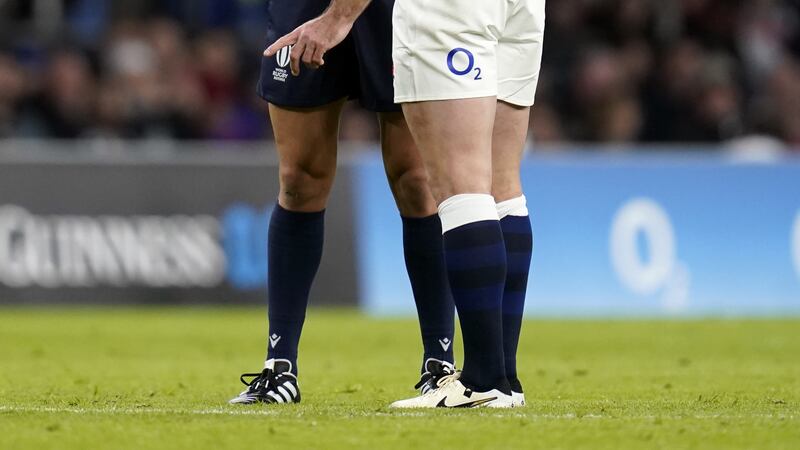 Referee James Doleman explains to George Ford why he allowed Wales to charge down