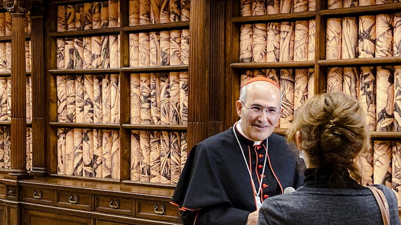 The Vatican Apostolic Librarian, Cardinal Jos&eacute; Tolentino de Mendon&ccedil;a, left, speaks to a journalist, Monday, November 8, 2021, during the presentation to the media of the exhibition &quot;Tutti&quot; (All) inside the Apostolic Library (AP Photo/Nicole Winfield)&nbsp;