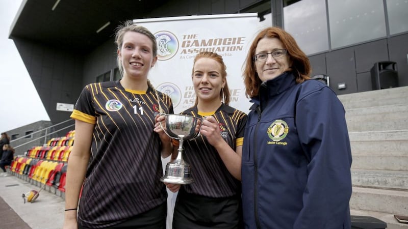 Leinster Camogie chairperson Hilda Breslin presents Ulster&#39;s Sinead Kieran and Niamh Donnelly with the Junior Interprovincial Championship cup after the Ulster girls defeated Munster at the National Sports Campus, Abbotstown, Dublin on May 19 2019. Picture by INPHO/Oisin Keniry 