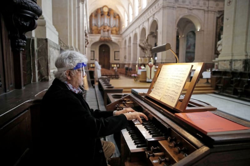 An organist in Saint Roch church in Paris wearing a protective shield face mask as part of the measures introduced in France, where public worship resumed last Saturday after a legal challenge to the government&#39;s ban on church gatherings. A Drumalis seminar series starting next week will explore what church will be like when collective worship eventually resumes in Ireland. Picture by AP Photo/Francois Mori 