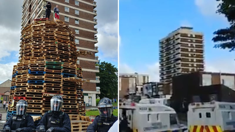 Two youths stayed on top of the New Lodge bonfire as police surrounded the structure this morning&nbsp;