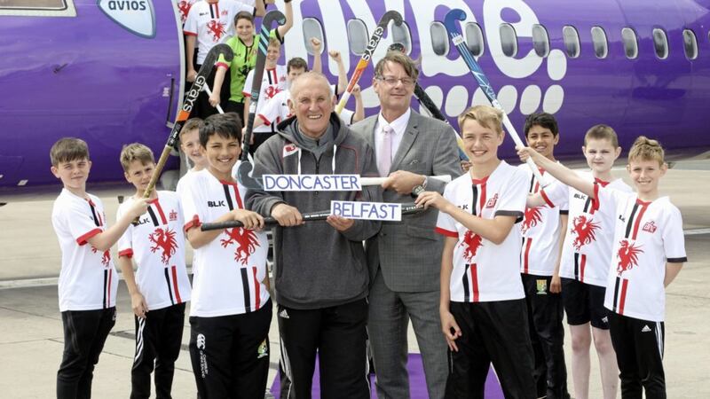 Ken Harrower, Flybe&rsquo;s country manager Ireland (right) and Annadale Under 13&rsquo;s coach, Ronnie Smyth &lsquo;push back&rsquo; the airline&rsquo;s inaugural flight to Doncaster. 