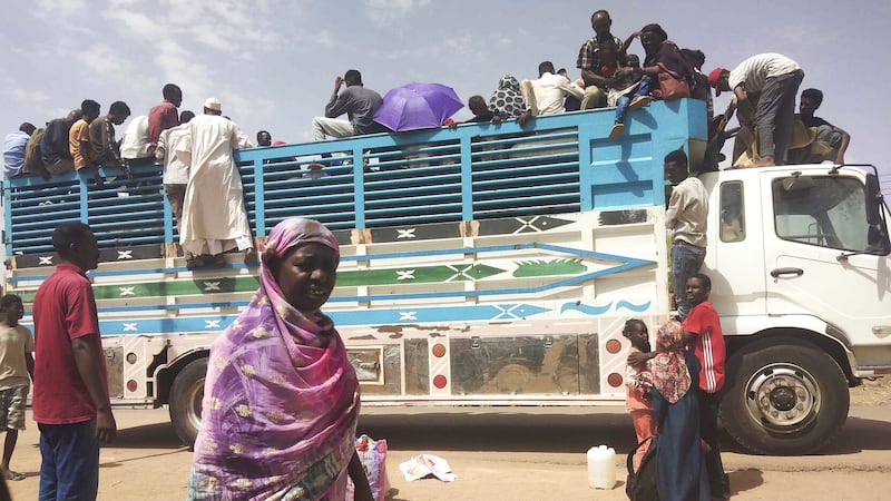 People board a truck to flee Sudan’s capital Khartoum as fighting continues (AP/PA)
