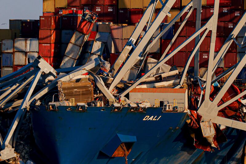 Part of the wreckage of the bridge rests on the container ship Dali (Julia Nikhinson/AP)