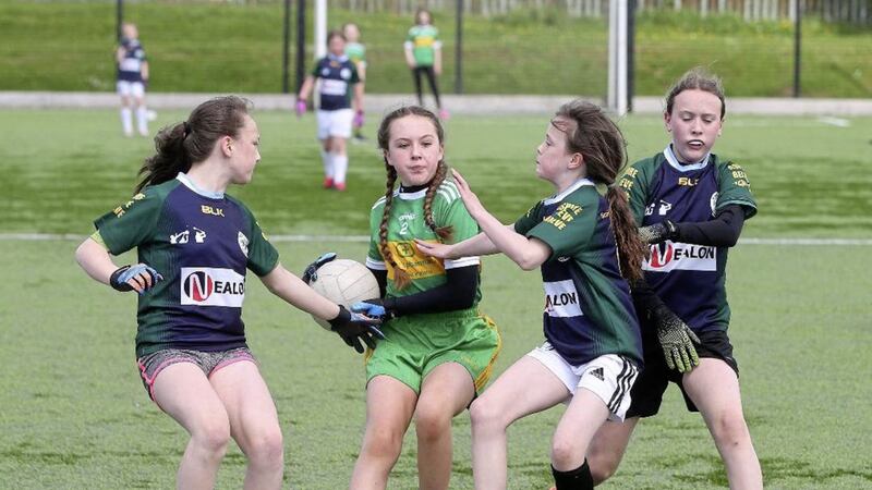 The girls of St John the Baptist and Bunscoil Phobal Feirste were backing competing in Gaelic football yesterday after an absence of over a year 