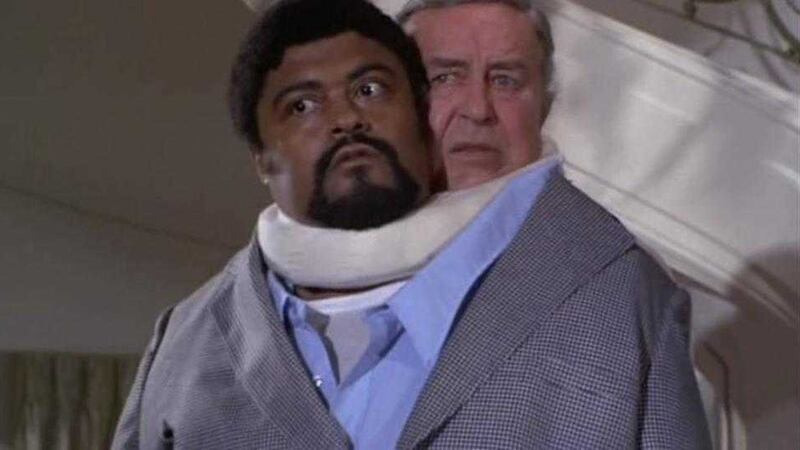 Rosey Grier and Ray Milland put their heads together 