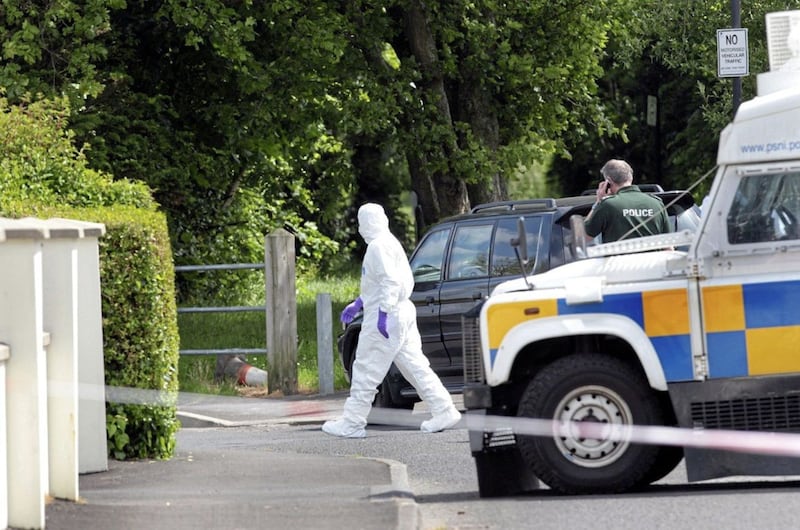 Forensics examine the scene where a bomb was found under the car of a serving PSNI officer in Eglinton village on the outskirts of Derry in 2015.