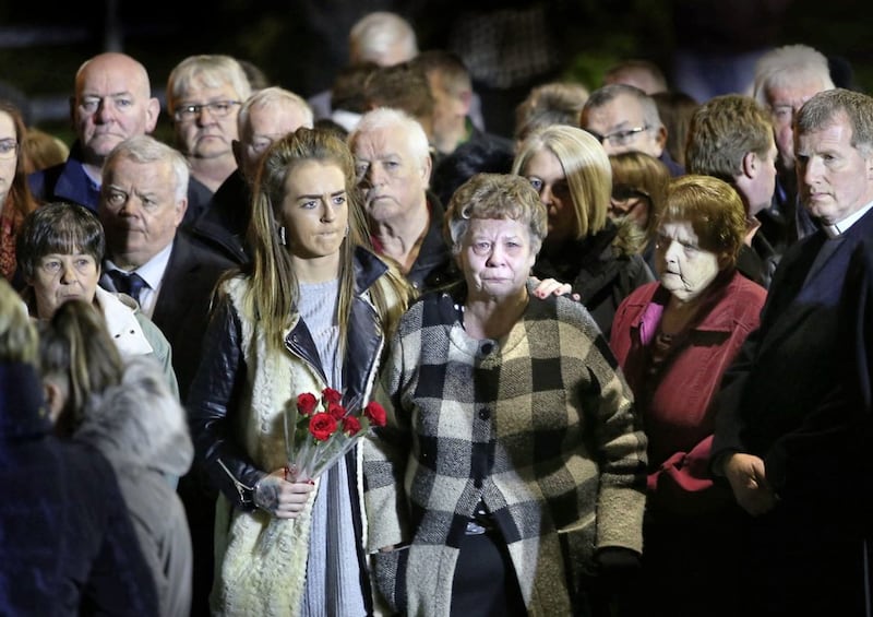 Family and friends gather at a memorial beside the Rising Sun bar in Greysteel to remember the eight people who died after a shooting inside the bar, on the 25th anniversary of the 1993 massacre. Mass was celebrated earlier in the evening at St Mary's Church in the Co Derry village. Picture by Margaret McLaughlin