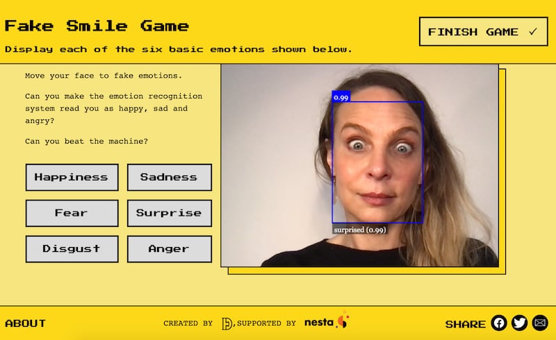 Dr Alexa Hagerty plays a game on the Emojify website, which demonstrates AI emotion recognition technology. (Cambridge University/ PA)