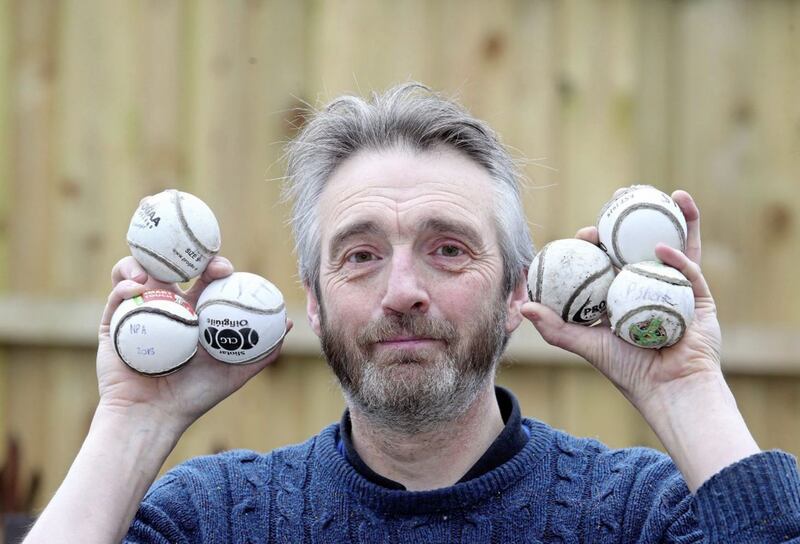 Corrib Avenue resident Stephen McCartney with some of the hurling balls that land in his garden from the nearby St Pauls GAA Club. 