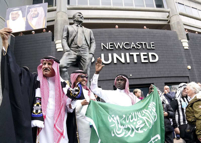 Newcastle fans celebrate the Saudi-led takeover of the club in October 2021