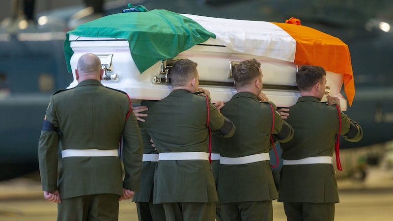 Members of the Irish Defence Forces carry the remains of a former comrade draped in the Irish tricolour. The use of the flag during funerals in some parts of the country is proving controversial. Picture by Tom Honan/PA Wire