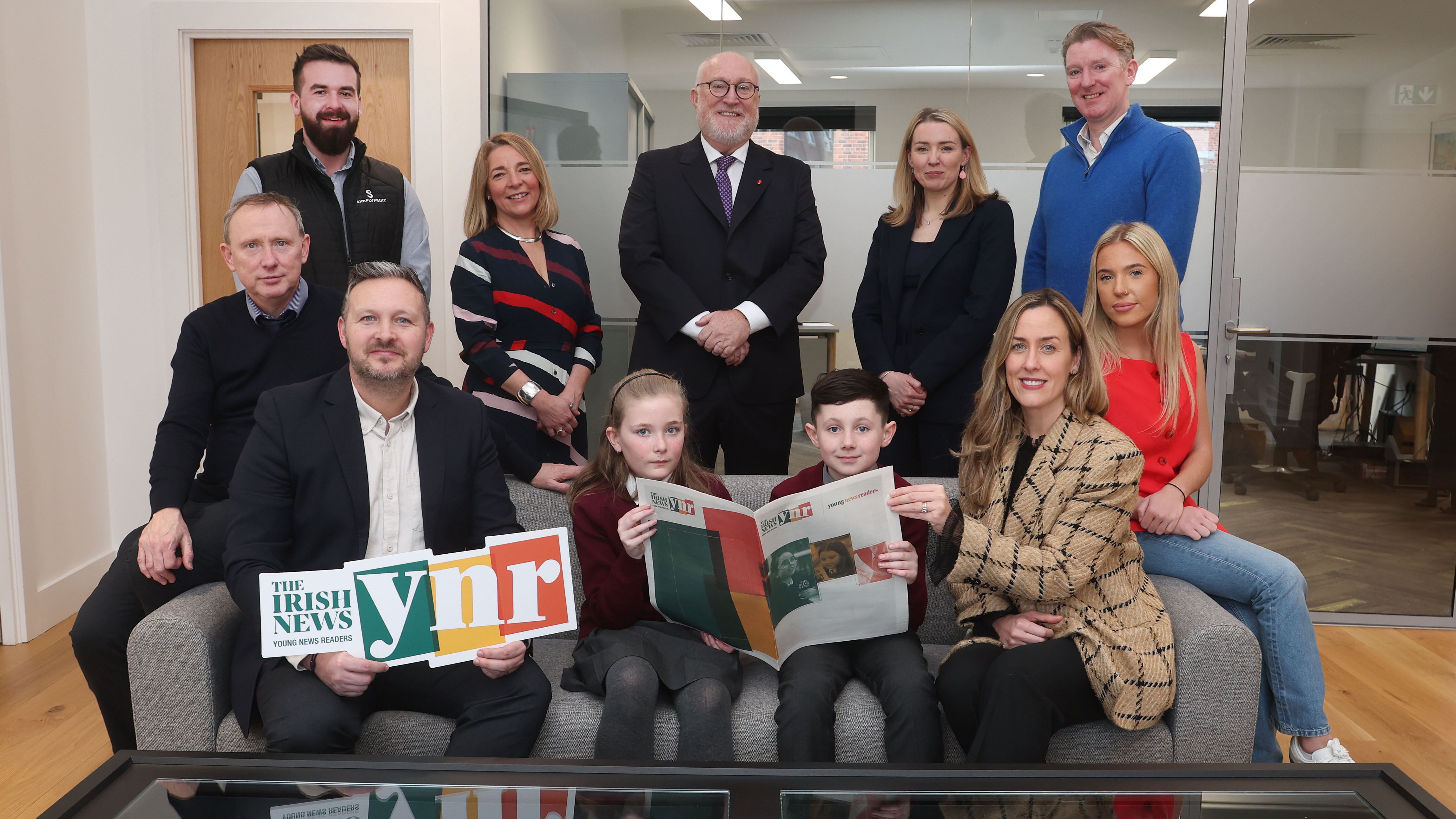 Front row (L-R): Mr White (teacher, Holy Trinity PS), Chris Sherrard (Irish News Editor-in-Chief), pupils from Holy Trinity PS, Annette McManus (Chief Marketing Officer, IntoMedia Group) and Ciana Bradley (education coordinator, West Belfast Partnership Board). Back row (L-R): Connor McCann (operations manager, Simplyfruit), Jo McGinley (social value director, EY), Prof Peter Finn (principal, St Mary’s University College), Aoife Warren (partner, EY), Damian Bannon (Belfast area manager, Translink)