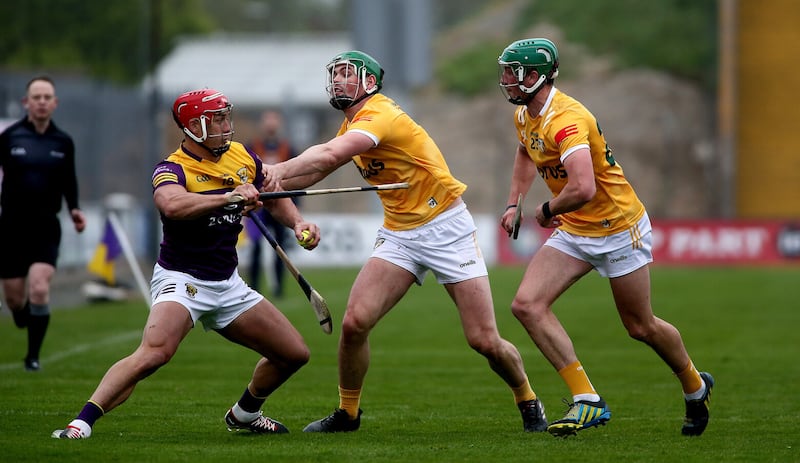 Paul Boyle in Antrim colours, challenging Wexford's Lee Chin.