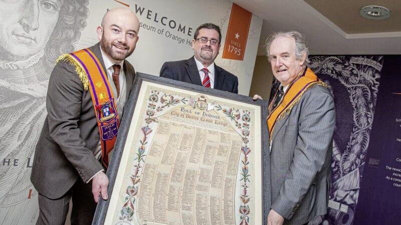 Chris McGimpsey (right) and Chris Thackaberry from Dublin and Wicklow LOL 1313 present the roll of honour to Dr Jonathan Mattison (centre) from the Museum of Orange Heritage. Picture by Graham Curry 