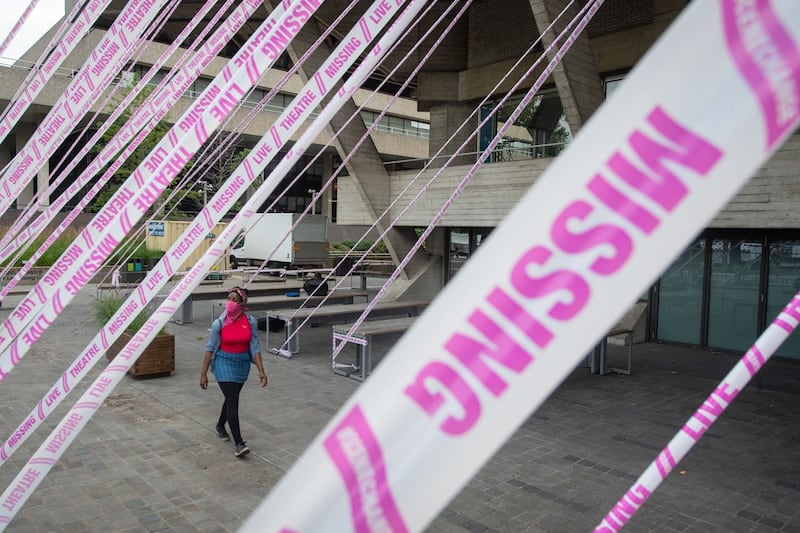 The National Theatre is wrapped in tape as part of a campaign to draw attention to the plight of UK theatre