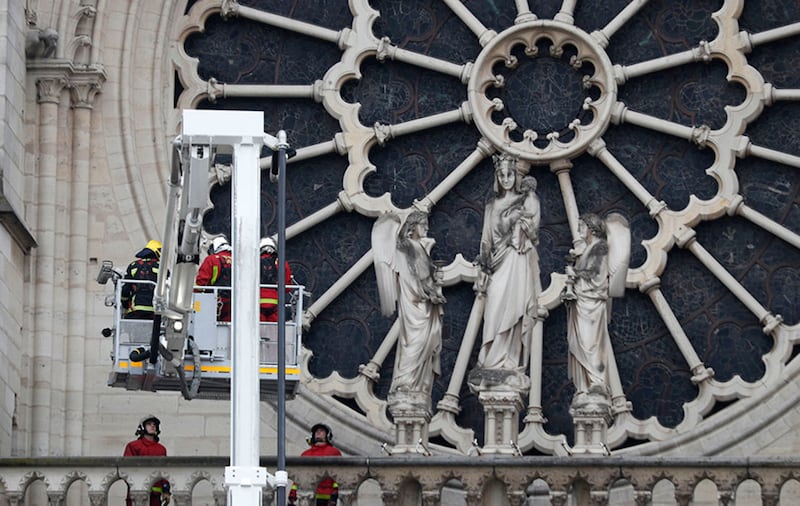 Firefighters work near the rose window of Notre Dame cathedral Tuesday April 16, 2019 in Paris&nbsp;