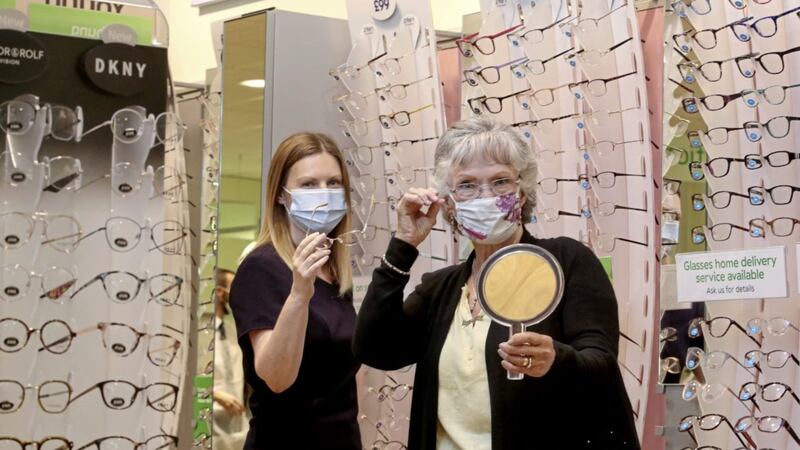 Director Lynsey Caldwell assists Margaret Johnston, who was one of the first customers through the doors of the Specsavers Connswater store in May 2001 