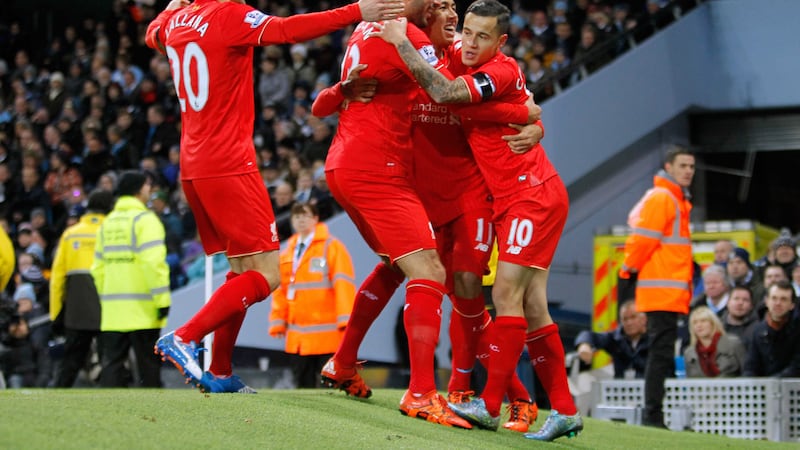 Liverpool celebrate after Manchester City's Eliaquim Mangala scored an own goal during the Barclays Premier League match on Saturday