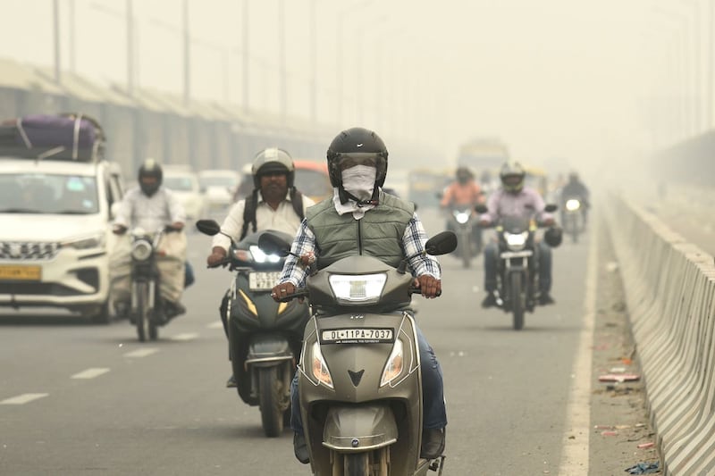 Motorcyclists wearing face masks in New Delhi
