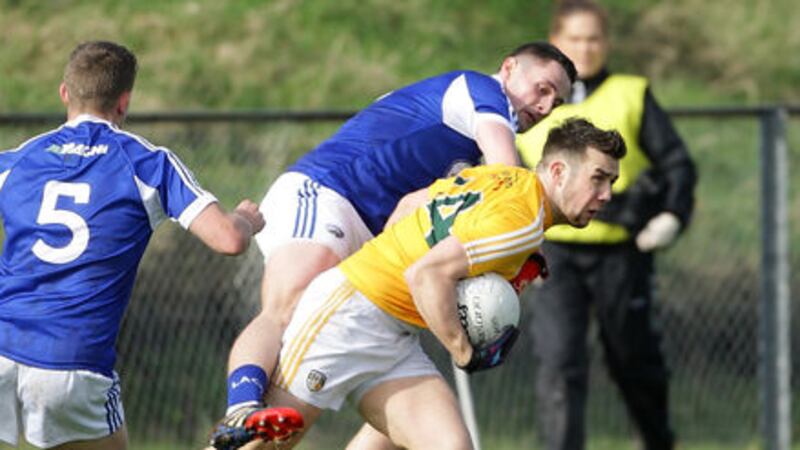Antrim's Conor Murray comes under pressure from Laois's James Finn at Corrigan Park, Belfast. Picture by Cliff Donaldson