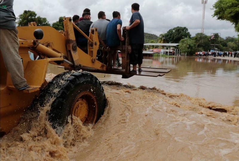 &nbsp;A heavy lifter carries people across a flooded area after the passing of Hurricane Iota in La Lima, Honduras, on November 18 2020. Picture by Delmer Martinez, AP