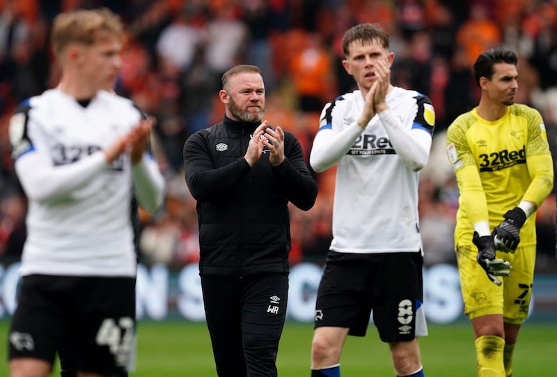 Wayne Rooney, centre, applauds the Derby fans after their game at Blackpool in April 2022