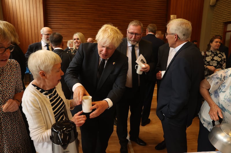 Hazel Sleeth giving British Prime Minister Boris Johnson a cup of tea after the funeral of former first minister and UUP leader David Trimble, who died last week aged 77, at Harmony Hill Presbyterian Church, Lisburn. Picture by Liam McBurney/PA Wire