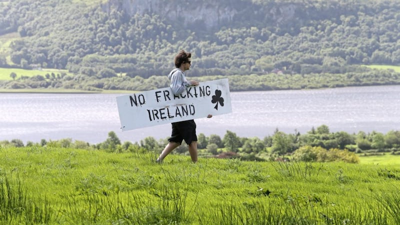 A protester carrys a sign at the the anti-fracking camp based at the site where Tamboran want to drill in Belcoo, Co Fermanagh in 2014 