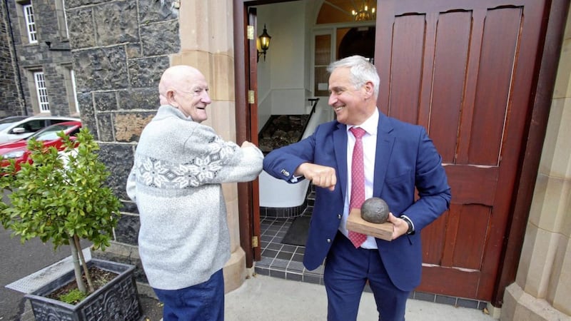 Walter Hemphill who was one of the first pupils through the door of St MacNissi&#39;s College when the school opened on September 3 1951 returns the cannonball he taken when he left the school more than six decades ago pictured with current principal of Garron Tower Jonny Brady. Picture by Mal McCann. 