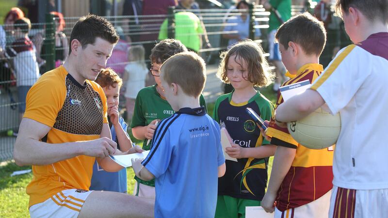 Antrim's John Cowan signs autographs for young fans during Monday night's training session at Belfast's MacRory Park <br />Picture by Cliff Donaldson