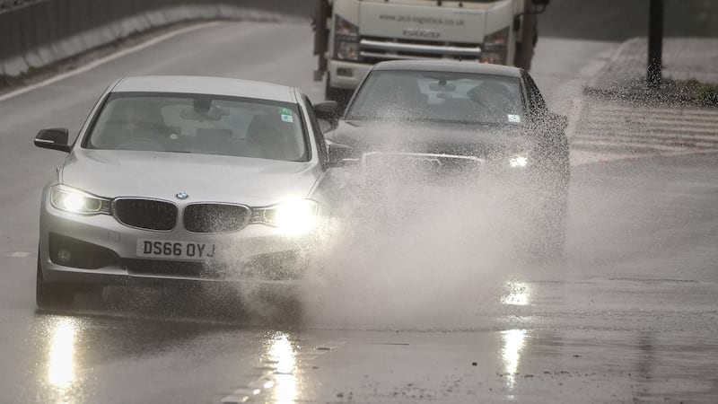 Cars drive through the rain on the A3