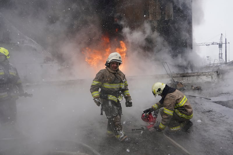 Firefighters extinguish a blaze after a Russian attack on a residential neighbourhood in Kharkiv (Andrii Marienko/AP)