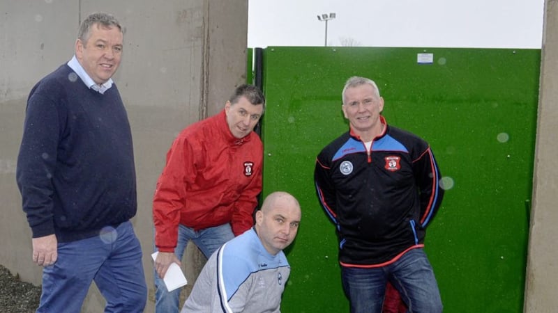 Tyrone GAA Chairman Michael Kerr inspects Beragh&#39;s flood defence project with (L-R) Ger Treacy (draw co-ordinator), Seamus McCrory (handball development officer) and Seamus Boyle (club chairman) Picture by Pat McSorley 