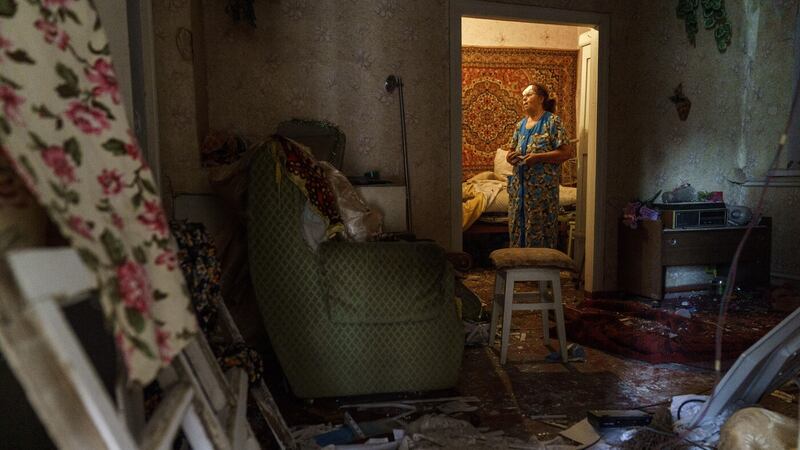Valentyna Kondratieva, 75, stands inside her damaged home Saturday, Aug.  13, 2022, where she sustained injuries in a Russian rocket attack last night in Kramatorsk, Donetsk region, eastern Ukraine (AP Photo/David Goldman)