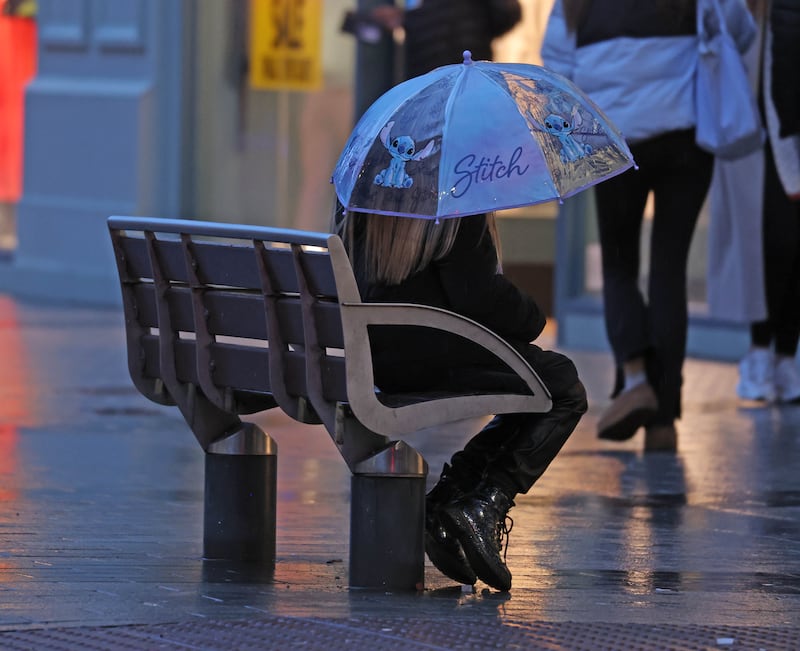 Sheltering from the storm in Belfast City Centre on Sunday, as Severe weather warnings have come into effect as Storm Isha arrives.
PICTURE: COLM LENAGHAN