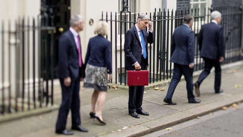 Chancellor Philip Hammond holding his red ministerial box outside 11 Downing Street, before heading to the House of Commons to deliver the Autumn Budget.               
