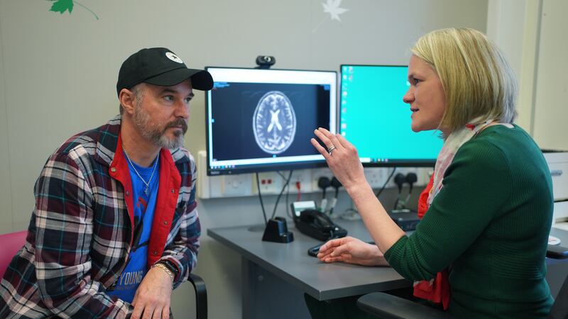 Consultant Dr Heather Shaw speaking to patient Steve Young, with an MRI of his brain on the screen, during a consultation at University College Hospital Macmillan Cancer Centre in London