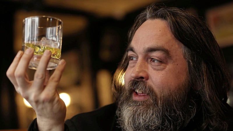 Conor Owens of Belfast Hidden Tours eyes a glass of Dunville&#39;s, now produced by The Echlinville Distillery in Co Down. Pictures by Mal McCann. 