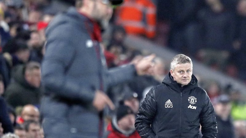 Manchester United manager Ole Gunnar Solskjaer (right) looks on, behind Liverpool boss Jurgen Klopp (left) during the clubs&#39; last meeting at Anfield. 