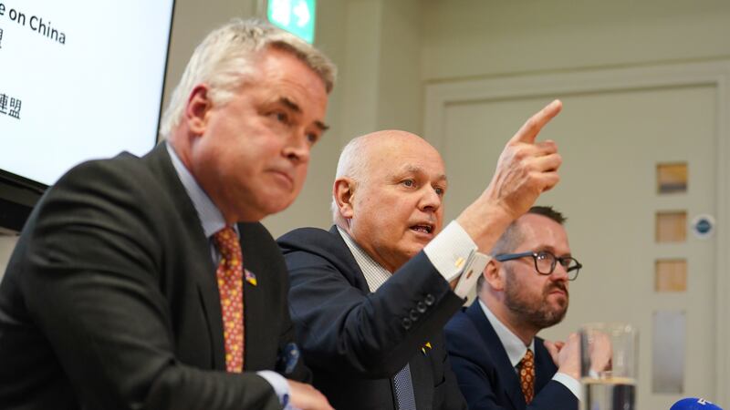 Sir Iain Duncan Smith (centre) renewed calls for China to be labelled a ‘threat’ rather than an ‘epoch-defining challenge’
