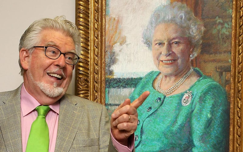Rolf Harris poses next to his portrait of Queen Elizabeth II 
